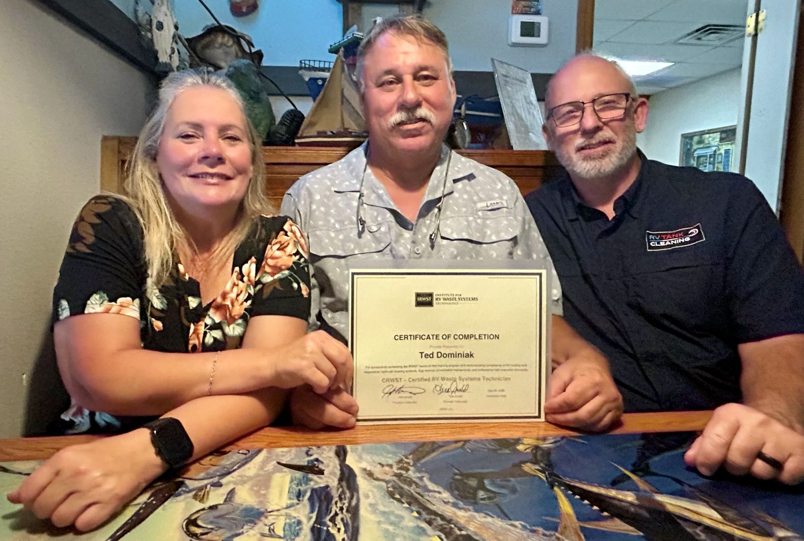 Ted Dominiak receiving his IRWST Certificate of Completion with Jeff and Tina Arnold